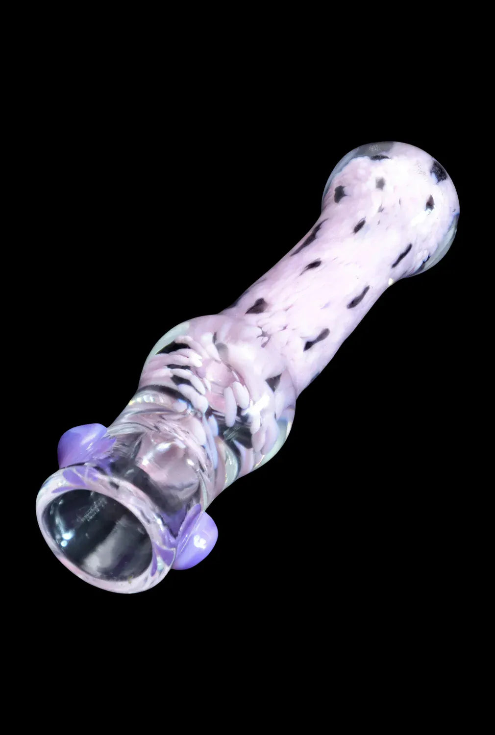 Angled close-up of the pink-and-white speckled DHC Frit Cone One Hitter - 3 in. resting against a black background, showing the flared mouthpiece and two purple glass knobs.