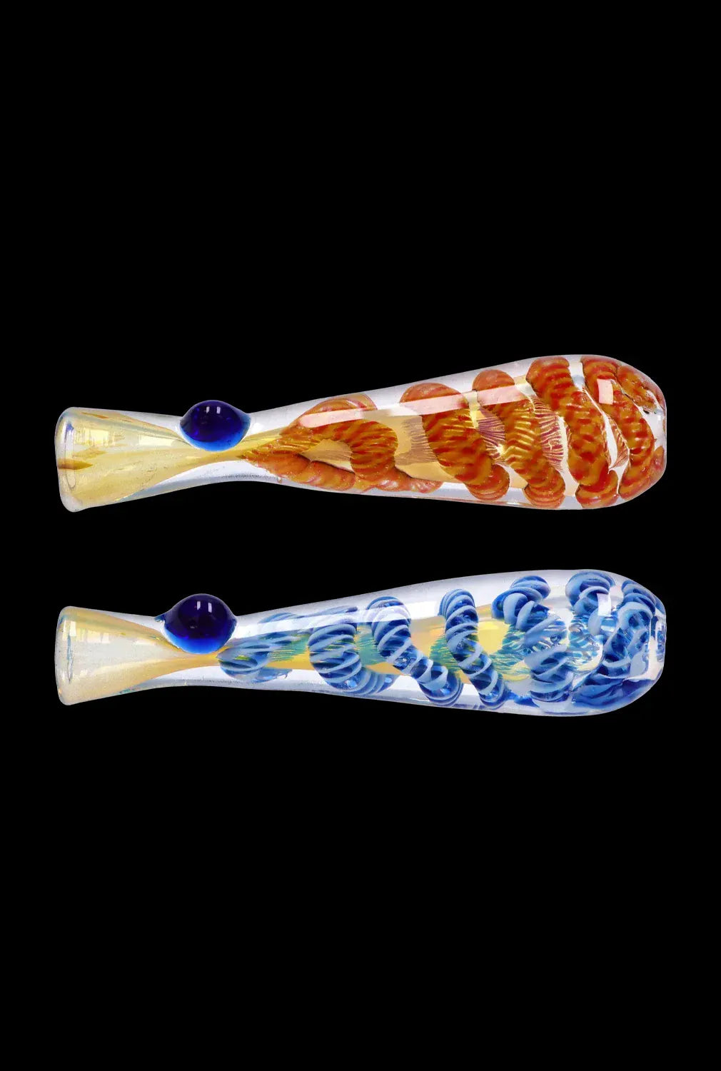 Side-by-side horizontal view of two DHC Piped and Fumed One Hitter - 3 in. glass pipes on a black background, one with orange spiral ribs and one with blue, each showing a small raised mouthpiece bead.