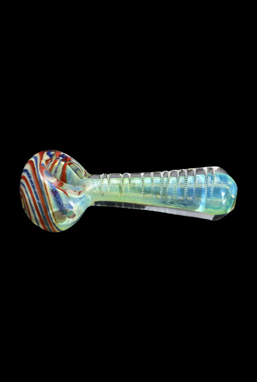 Side view of the DHC Engraved Fumed Spoon Pipe - 3 in., showing a clear iridescent stem with engraved ridges and a swirled red, white, and blue bowl against a black background.