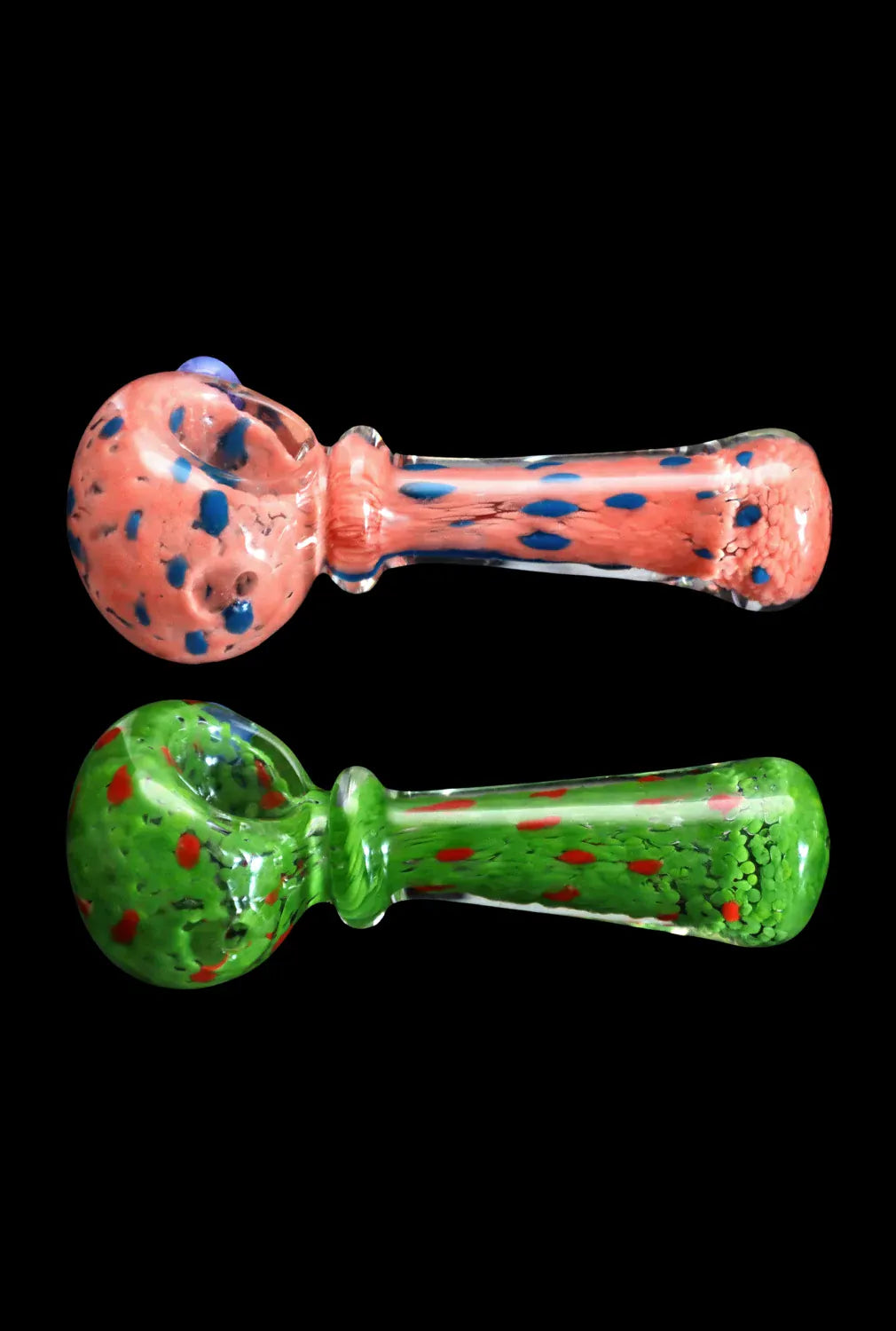 Top-down view of two 4 in. DHC Frit with Twisted Mouthpiece Spoon Pipe models, one coral with blue flecks above a green version with red speckles against a black background