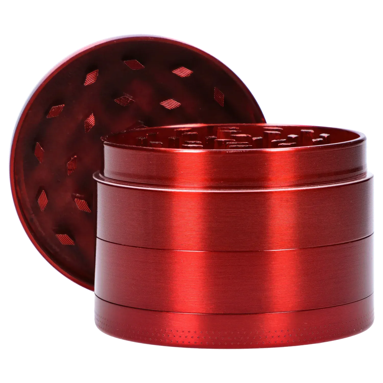 Close-up angled view of the red DHC Grooved 3-Stage Grinder - 52mm showing its stacked cylindrical chambers and open lid with diamond-shaped holes.