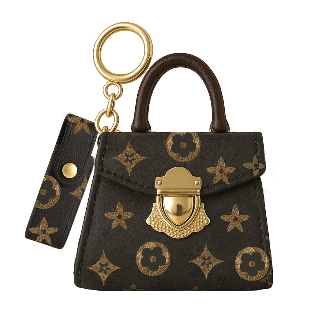Front-facing image of the black floral-patterned Penjamin Pursejamin Vaporizer keychain purse with a curved brown handle and gold clasp and ring.