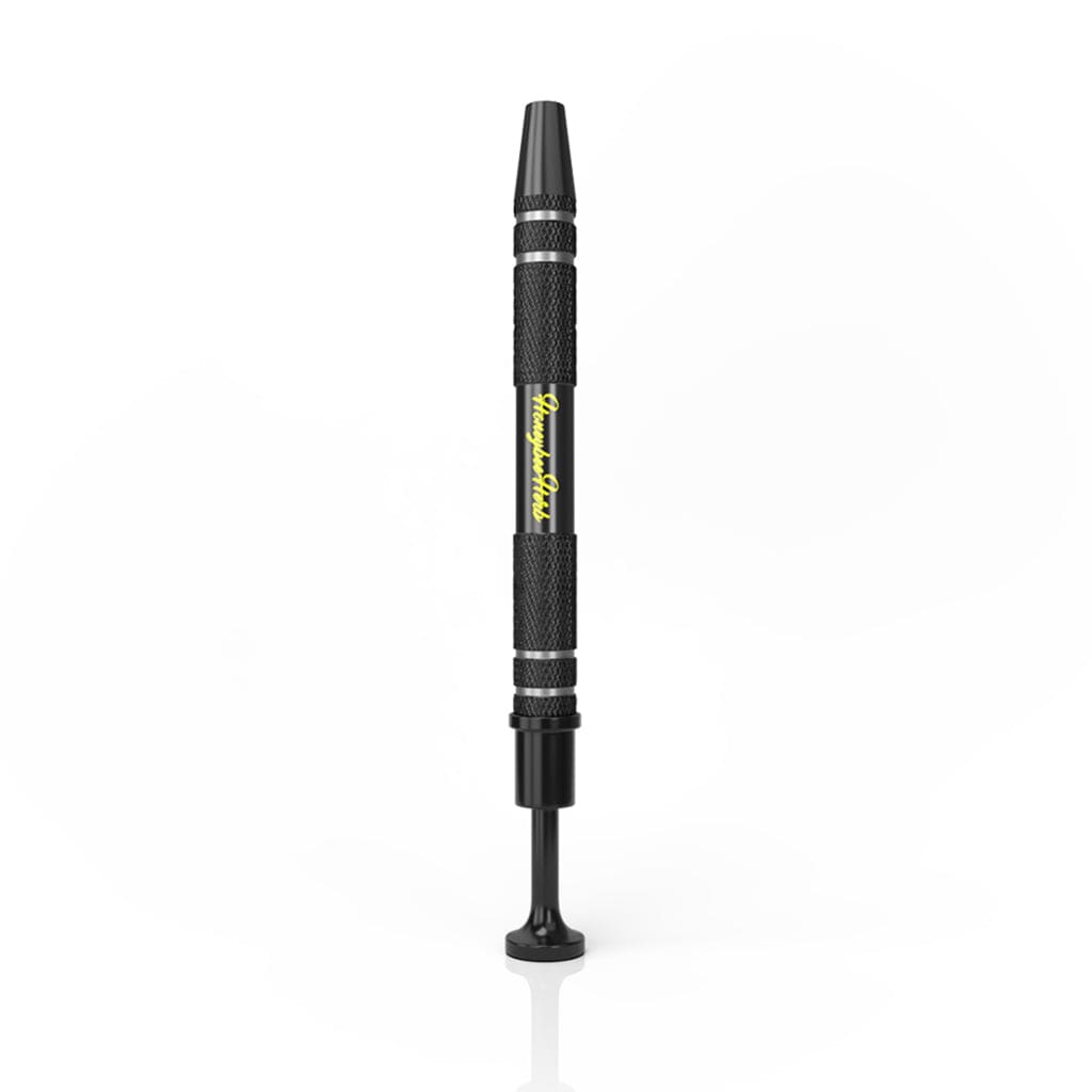 Vertical studio shot of the black Honeybee Herb Dab Claw centered on a white background, showing textured grip and yellow logo.