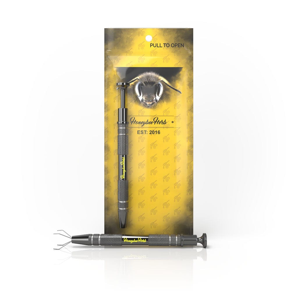 Front view of the Honeybee Herb Dab Claw against its yellow branded backing, shown upright and a second tool lying horizontally.