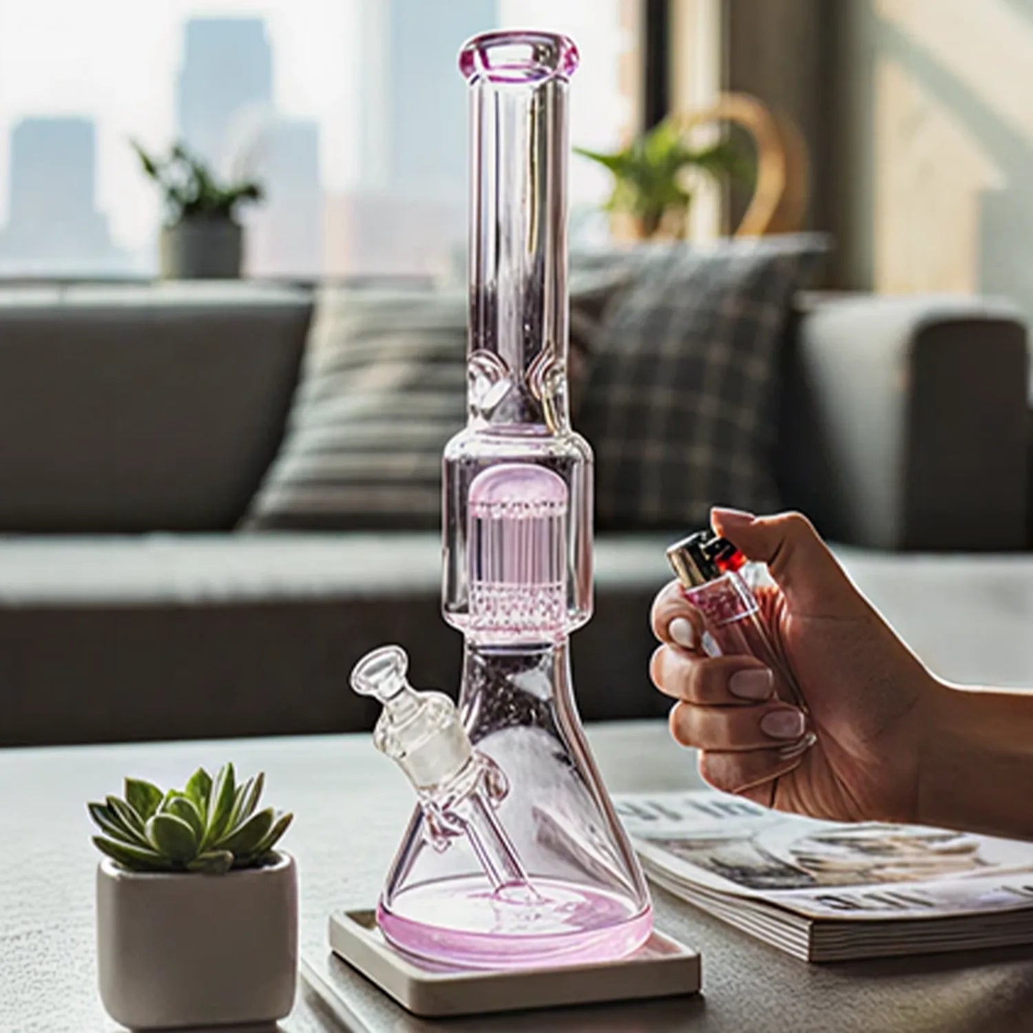 Close-up, front view of the DHC 9mm Beaker with Tree Perc Bong - 18 in. showing a pink-tinted glass beaker and tree percolator on a living room coffee table.