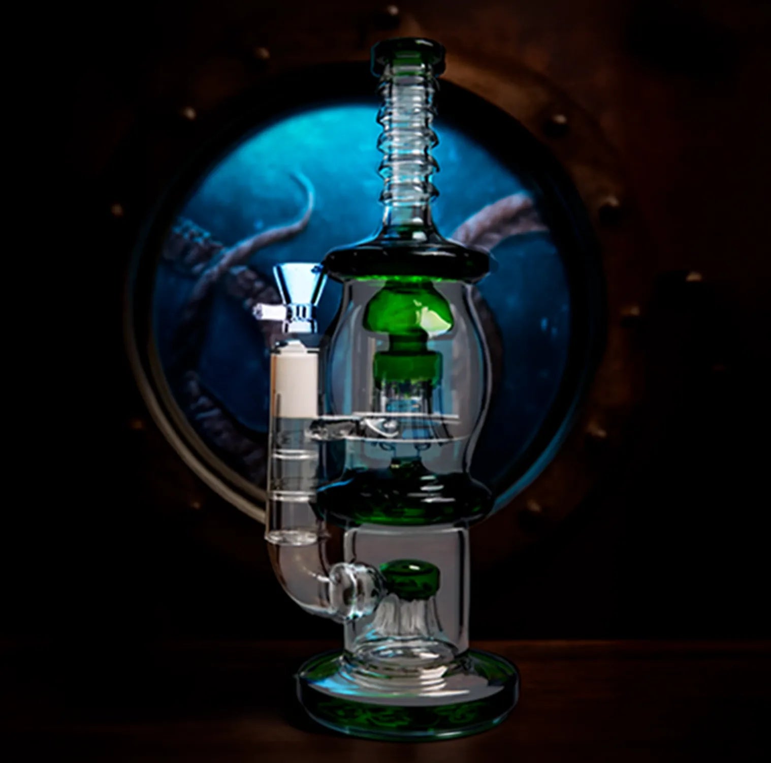 Centered, slightly low-angle close-up of the DHC Straight Tube with Dual Octopus Perc - 13.5 in. showing green-accented glass chambers against a round porthole backdrop.