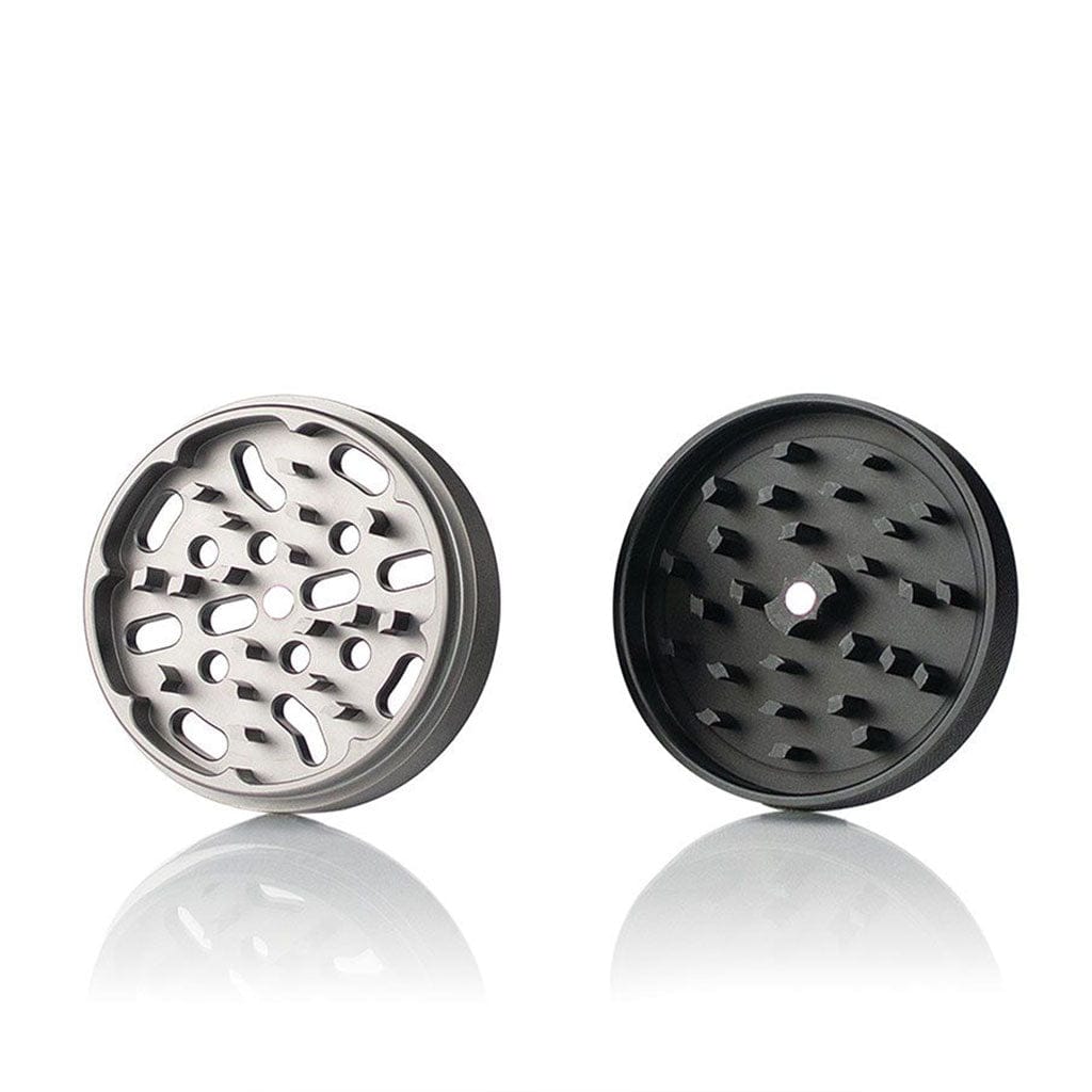Front-facing view of two circular Ryot 4Pc Jar Body Grinders halves, one silver and one black, shown open on a white reflective surface.