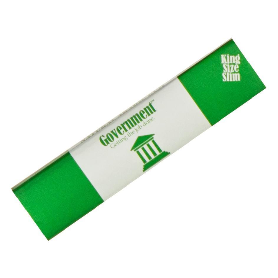 Diagonal top-down view of a green-and-white Government Rolling Papers - King Size pack showing the brand name and courthouse logo on a white background