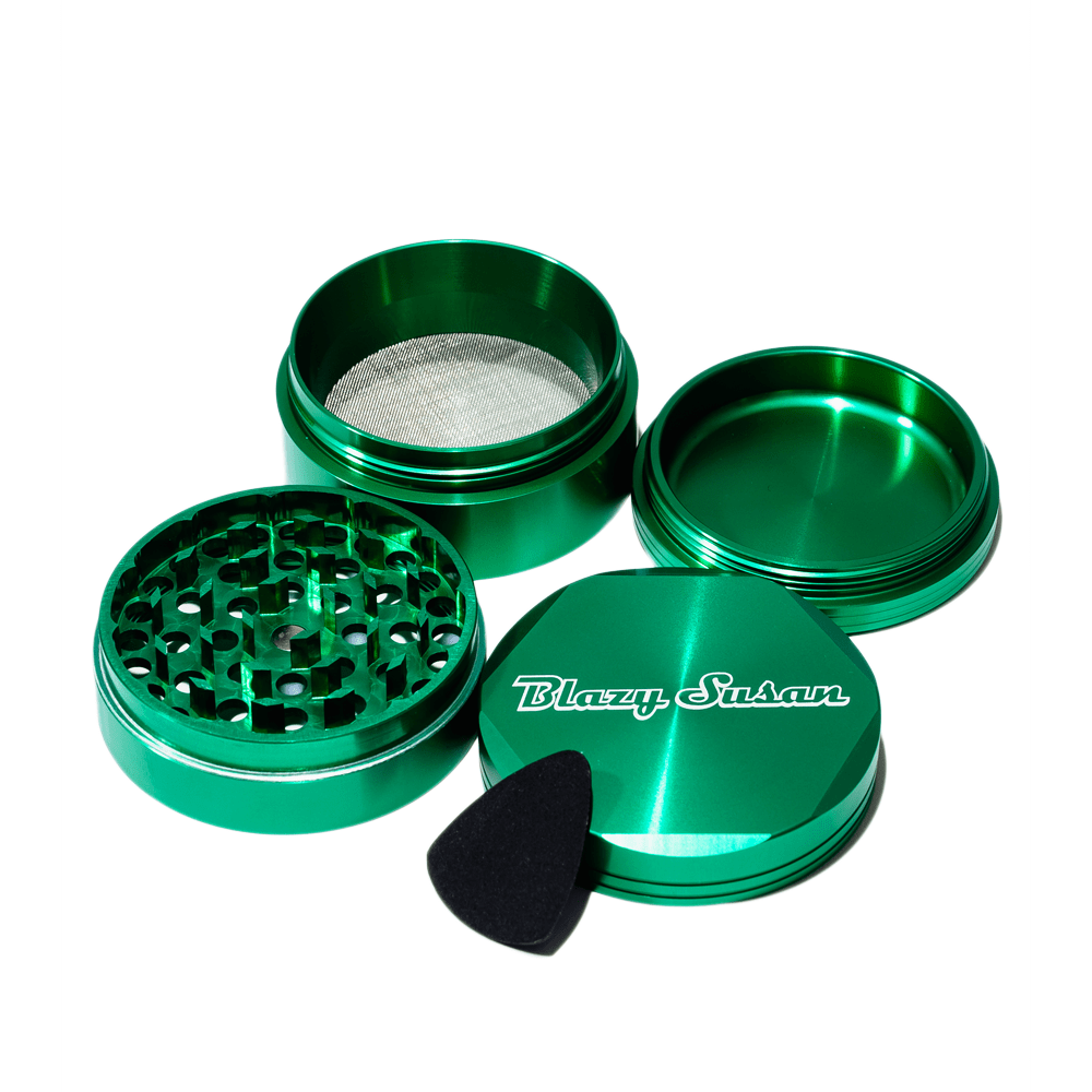 Angled top-down view of a metallic green Blazy Susan 4-pc 3 Chamber Grinder with its four pieces separated on a white background.