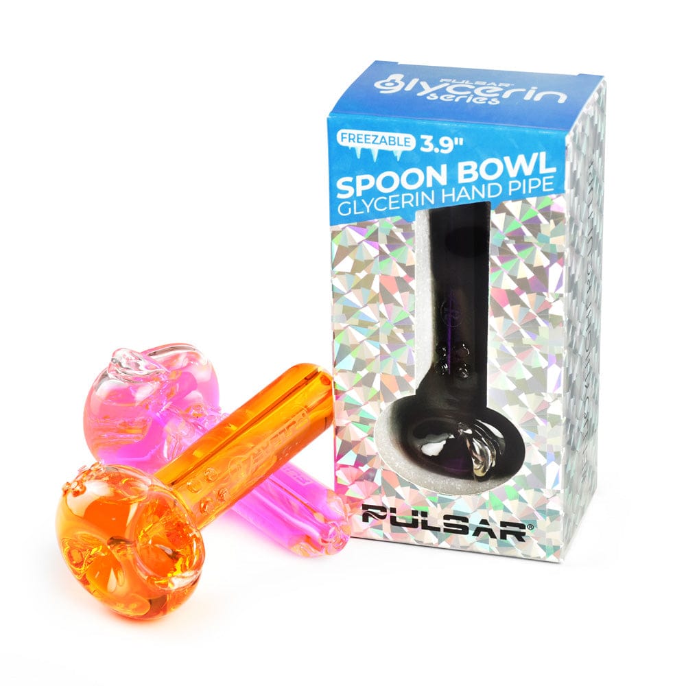 Angled view of two translucent colorful spoon pipes beside the box for Pulsar Glycerin Series Freezable Spoon Bowl Hand Pipe - 4"/Colors Vary.