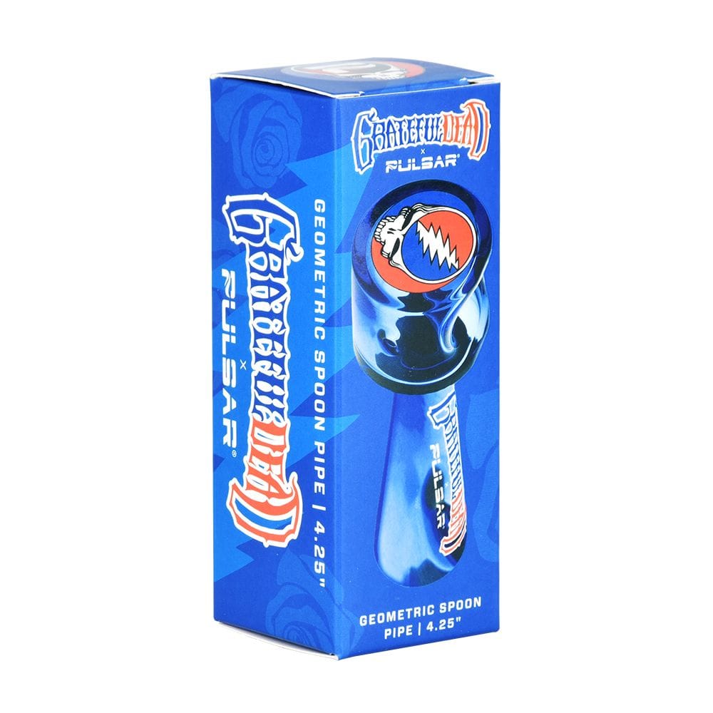 Angled front view of the Grateful Dead X Pulsar Geometric Glass Spoon Pipe | 4.25" retail box showing blue artwork, logo, and product image.