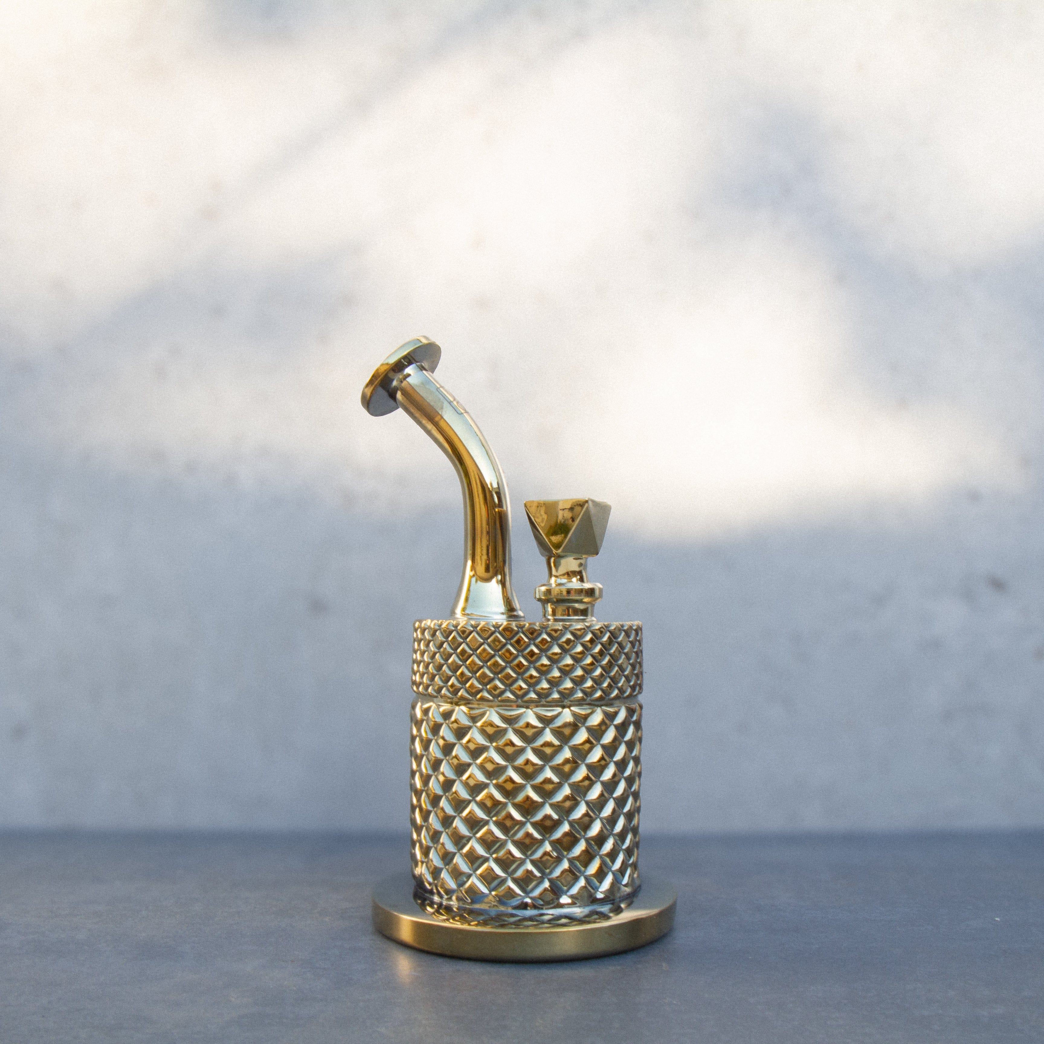 Close-up front view of the gold Twenties Collection Bong | Gold showing its textured cylindrical body and curved mouthpiece.