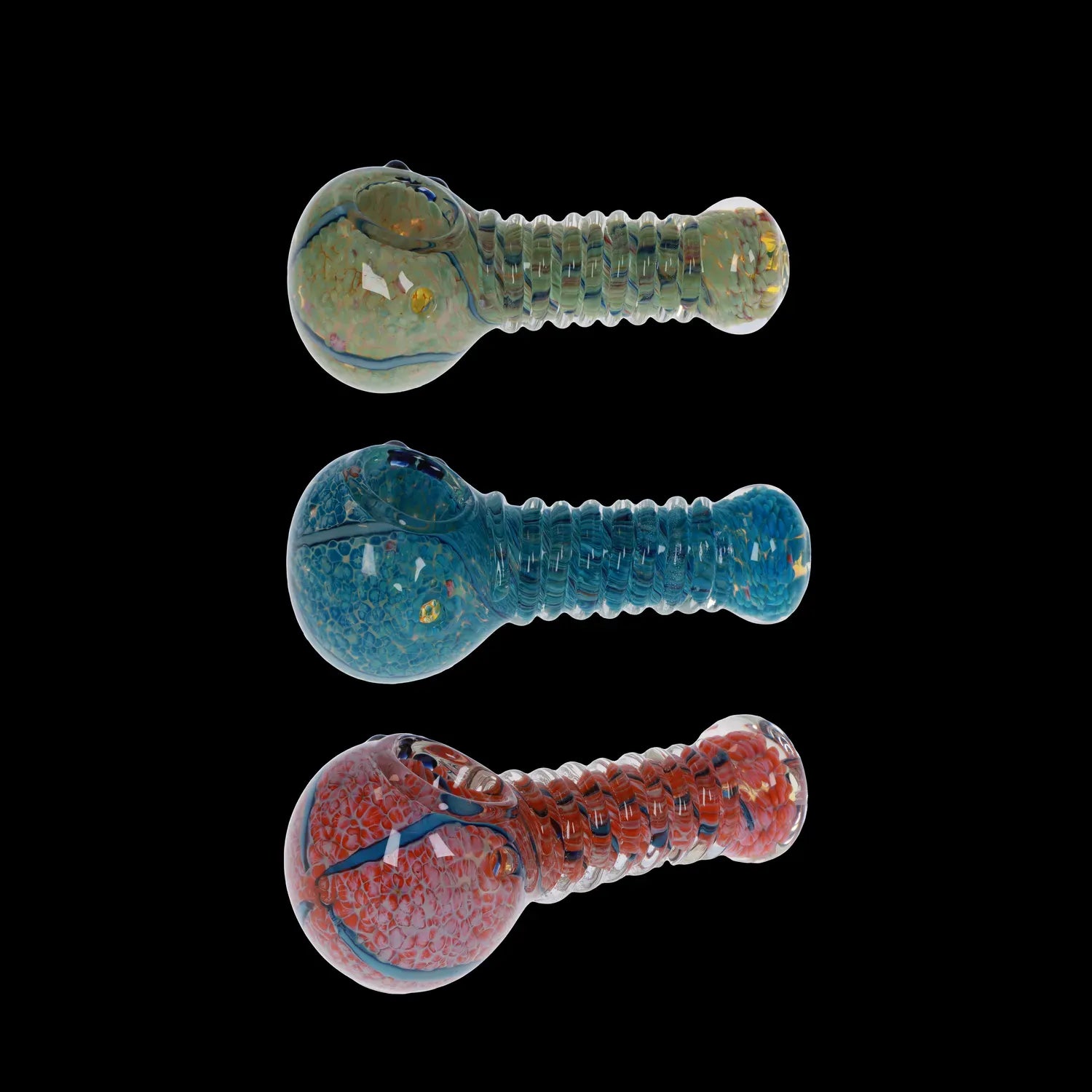 Top-down view of three colorful DHC Twisty Wrap Spoon Pipe - 5in. glass handpipes aligned vertically against a black background.