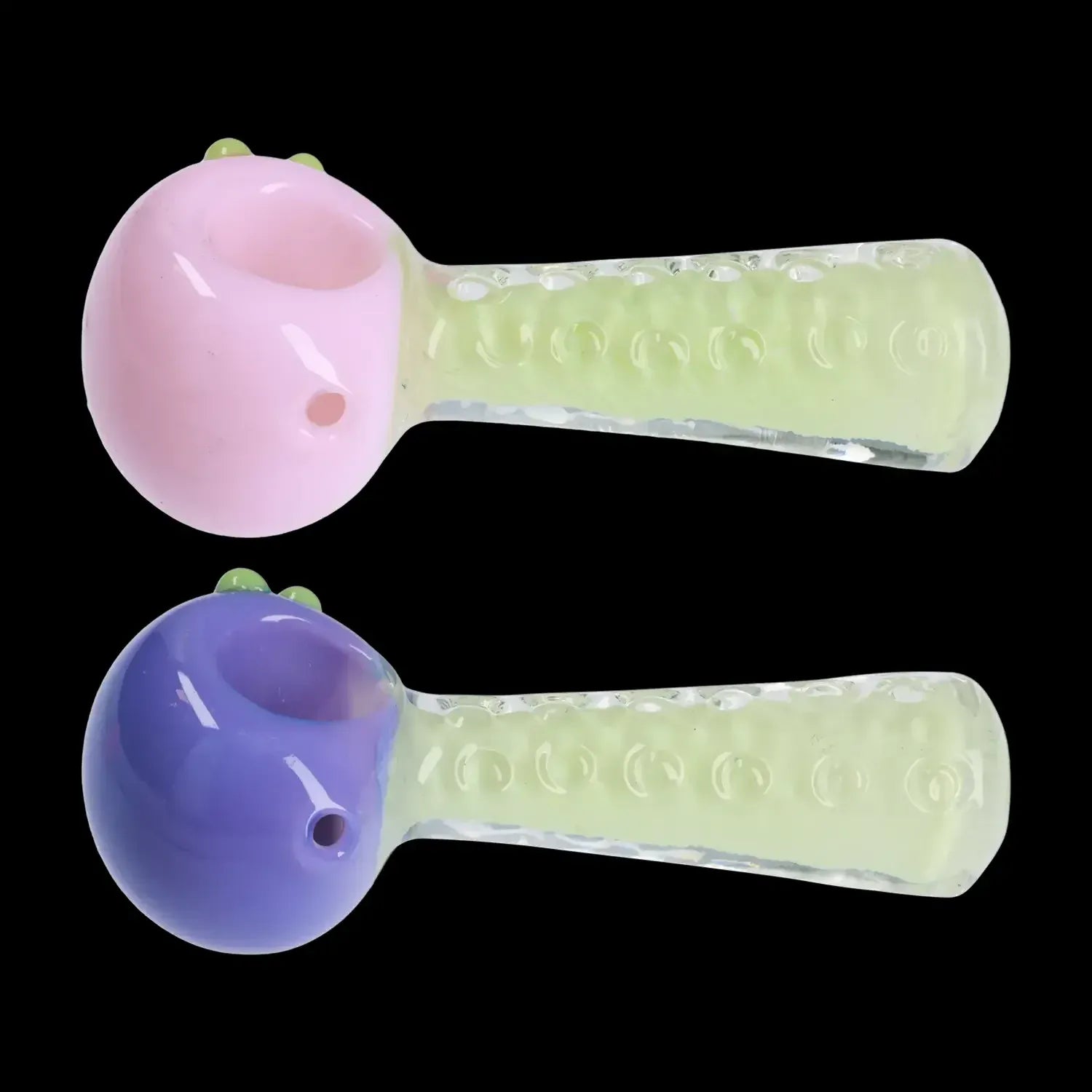 Side view of two DHC Fancy Stem Spoon Pipe - 4.5 in. models showing pastel pink and purple rounded bowls with translucent, textured green stems on a black background