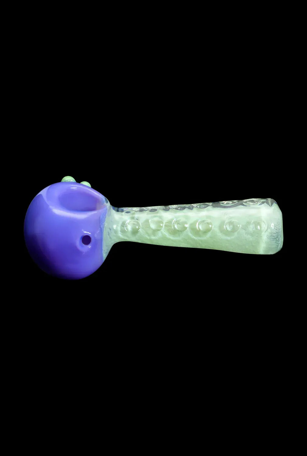 Side view of the DHC Fancy Stem Spoon Pipe - 4.5 in., showing a purple rounded bowl connected to a translucent textured stem against a black background