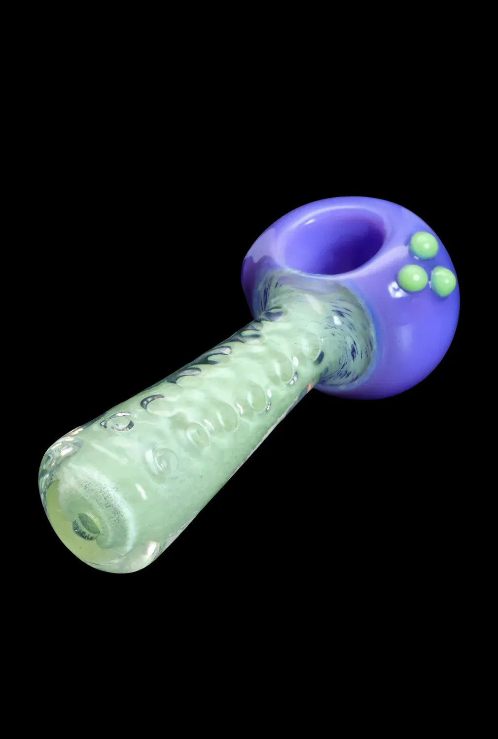 Angled close-up of the DHC Fancy Stem Spoon Pipe - 4.5 in. showing a purple bowl with three green dots and a textured pale green stem.