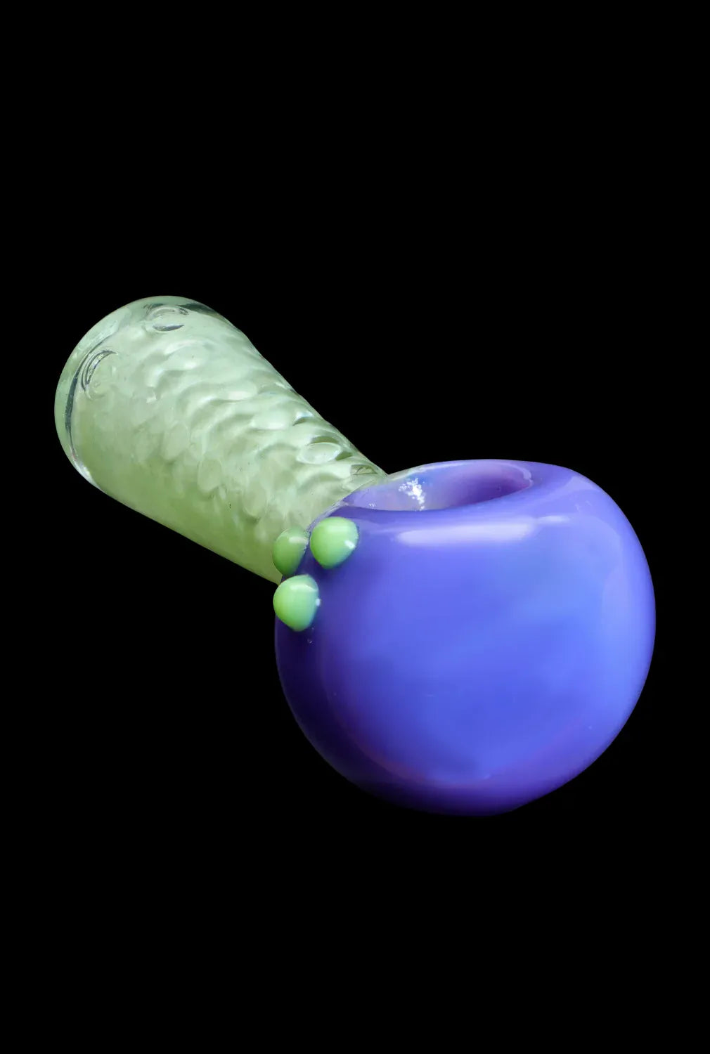 Angled close-up of the DHC Fancy Stem Spoon Pipe - 4.5 in. showing a glossy purple bowl with three green glass dots and a textured translucent green stem on a black background.