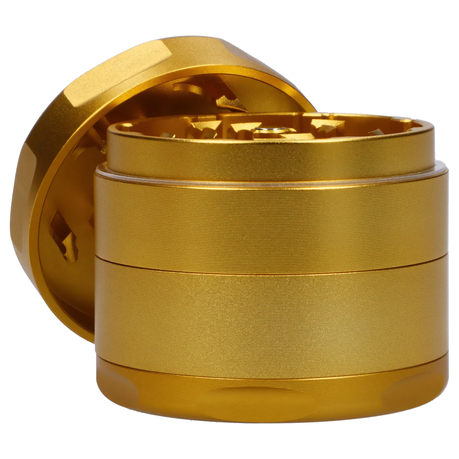 Close-up, low-angle view of the gold Famous X Surrender Aluminum 3 Stage Grinder-Gold showing its textured stacked chambers and exposed teeth.