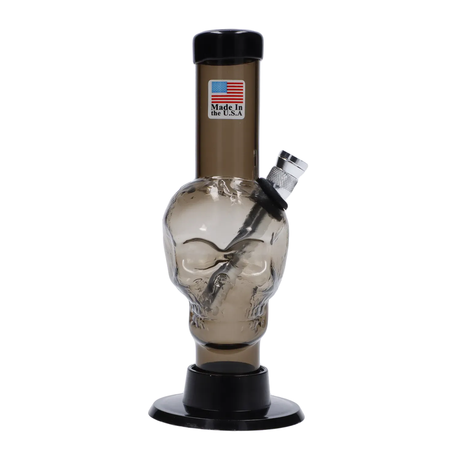 Front-facing close-up of the JM Plastics Mini Skull Base Acrylic Bong - 6 in. showing its smoky skull chamber, angled metal bowl, and black base on a white background