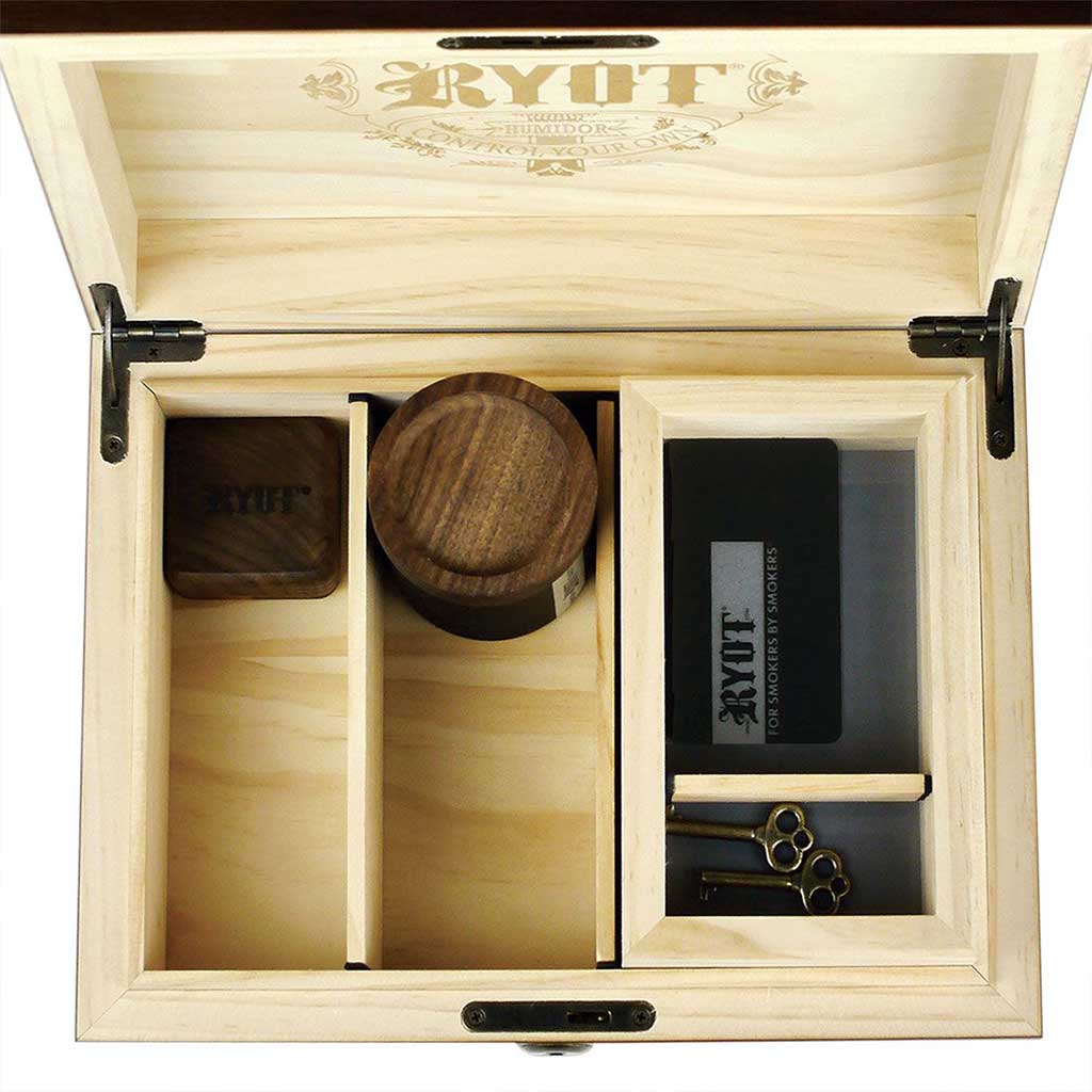 Top-down view of an open Ryot Humidor Walnut Combo Box showing three divided compartments, a round walnut jar, a small square walnut box, and a clear-sided section with keys.