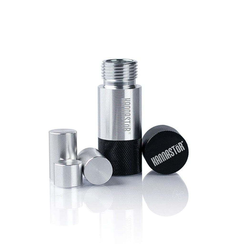 Close-up front view of the Ryot Kannastor Kief Press Pollen showing its disassembled silver and black cylindrical pieces arranged on a reflective white surface.