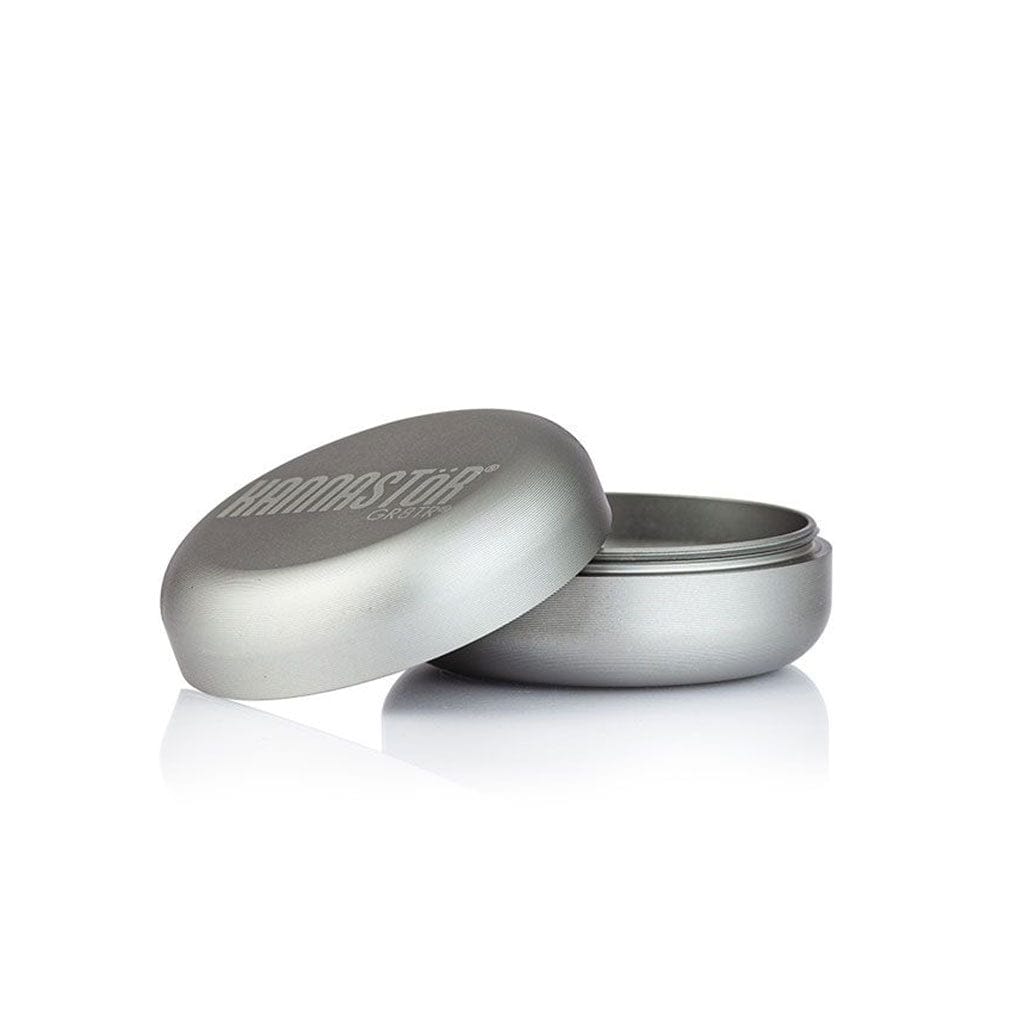 Angled close-up of a silver Ryot Gr8Tr Solid Body Grinder with its lid partially removed, shown on a reflective white surface.