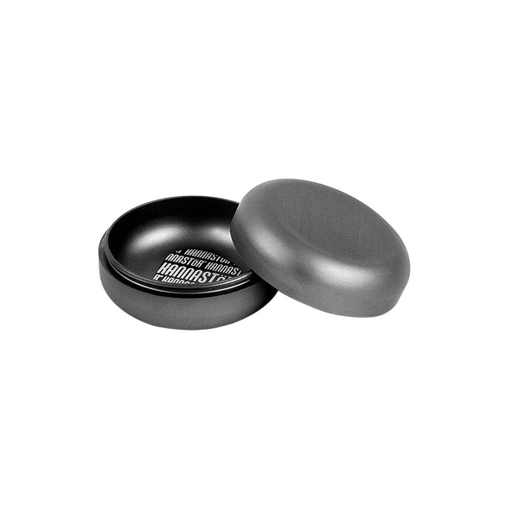 Angled top-down view of the open Ryot Gr8Tr Jar Body Grinder showing its matte gray rounded lid and shallow black interior with white logo text.