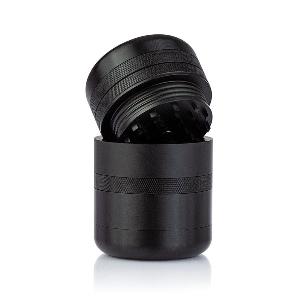 Close-up front view of the black Ryot Gr8Tr Solid Body Grinder with its textured lid tilted open to reveal inner teeth against a white background