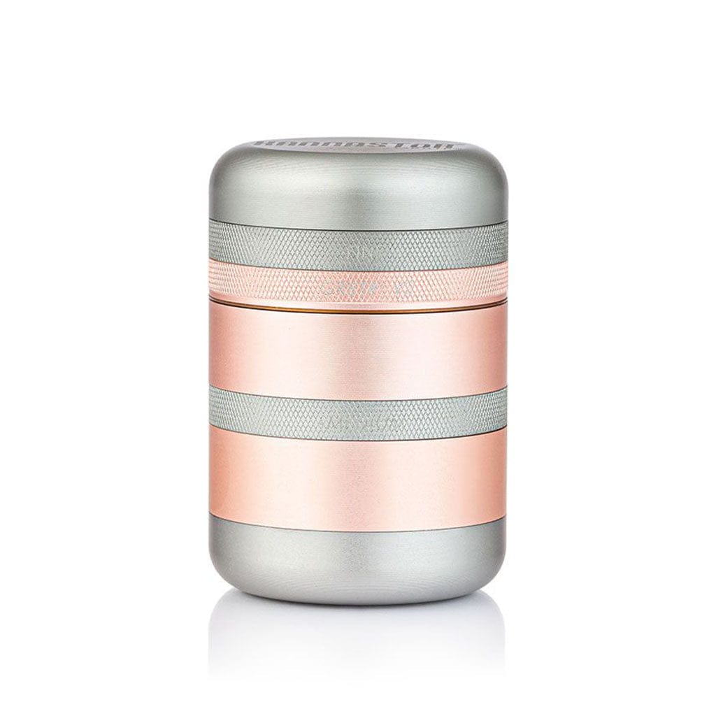 Centered studio shot of a metallic two-tone Ryot Gr8Tr Solid Body Grinder showing its cylindrical stacked layers and textured grip bands.
