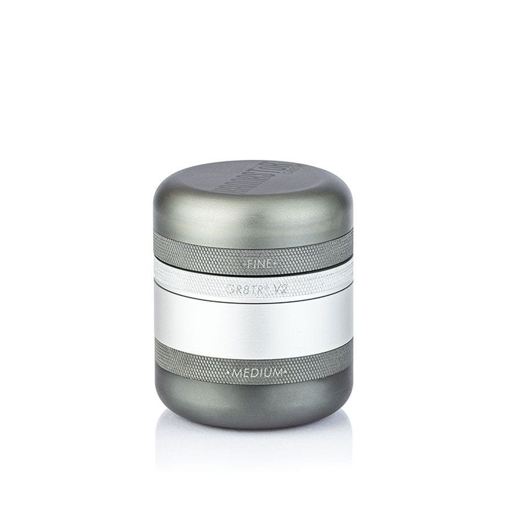 Front three-quarter view of the Rose Gold Ryot Gr8Tr Solid Body Grinder centered on white with visible knurled bands and engraved "FINE" and "MEDIUM" labels.