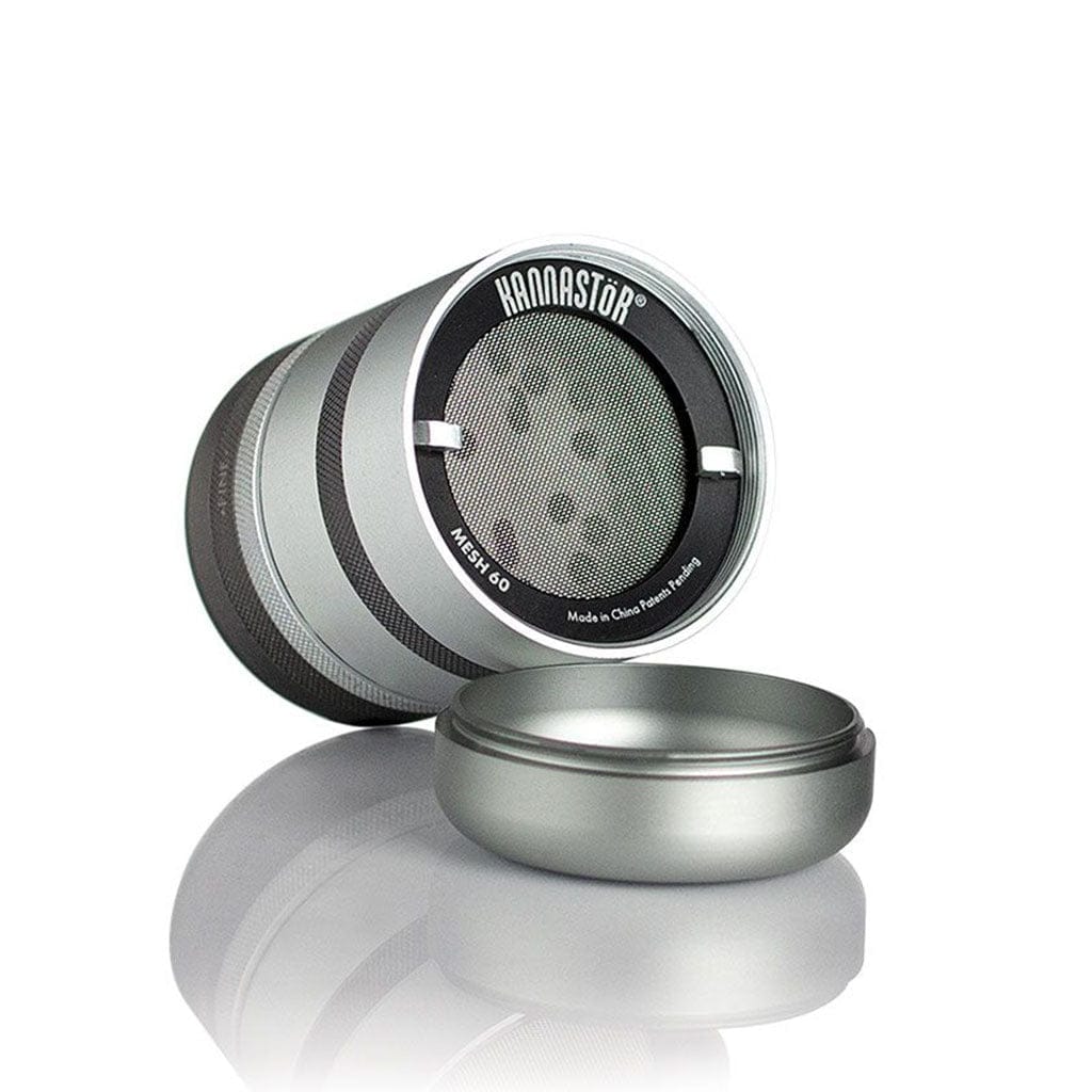 Angled close-up of the silver Ryot Gr8Tr Solid Body Grinder showing its open mesh screen and detached lid against a white reflective background