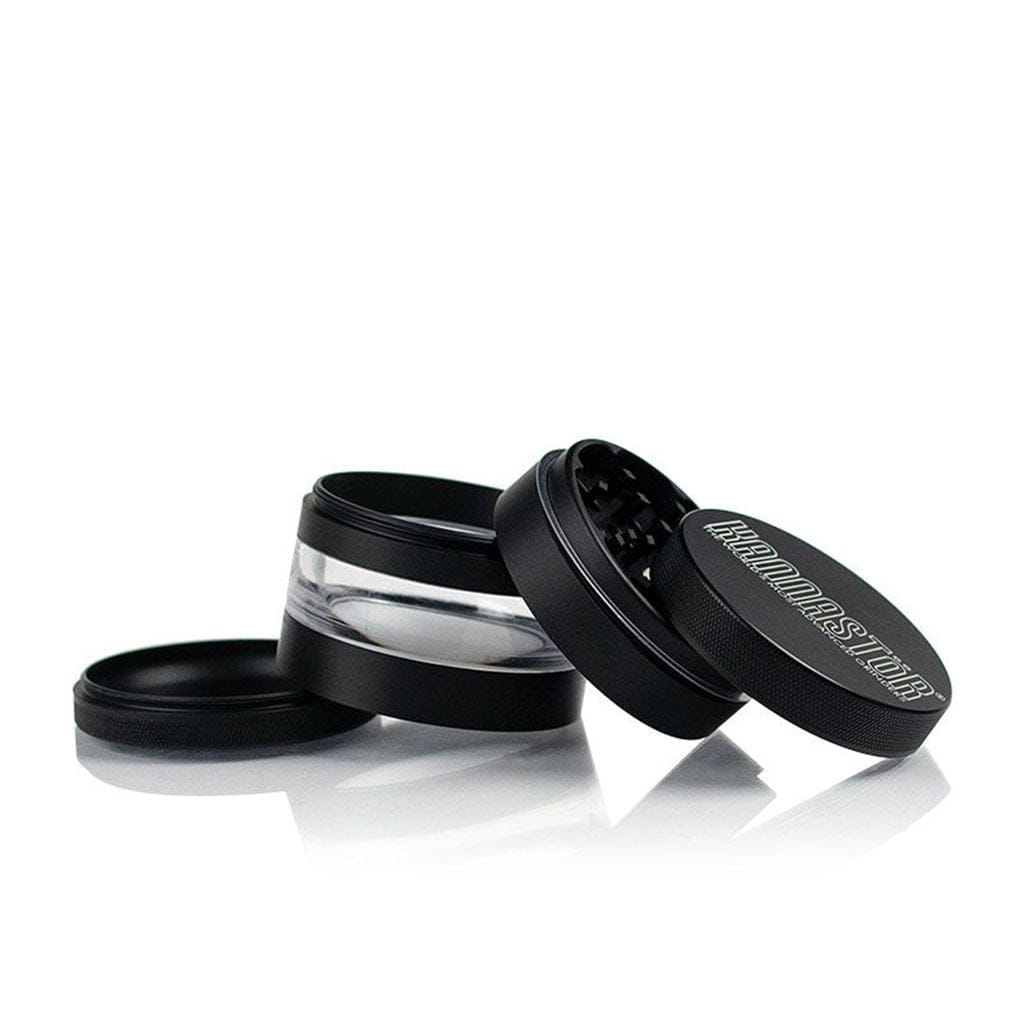 Angled studio shot of the black Ryot 4Pc Jar Body Grinders showing three separated sections and a clear middle chamber on a white reflective surface