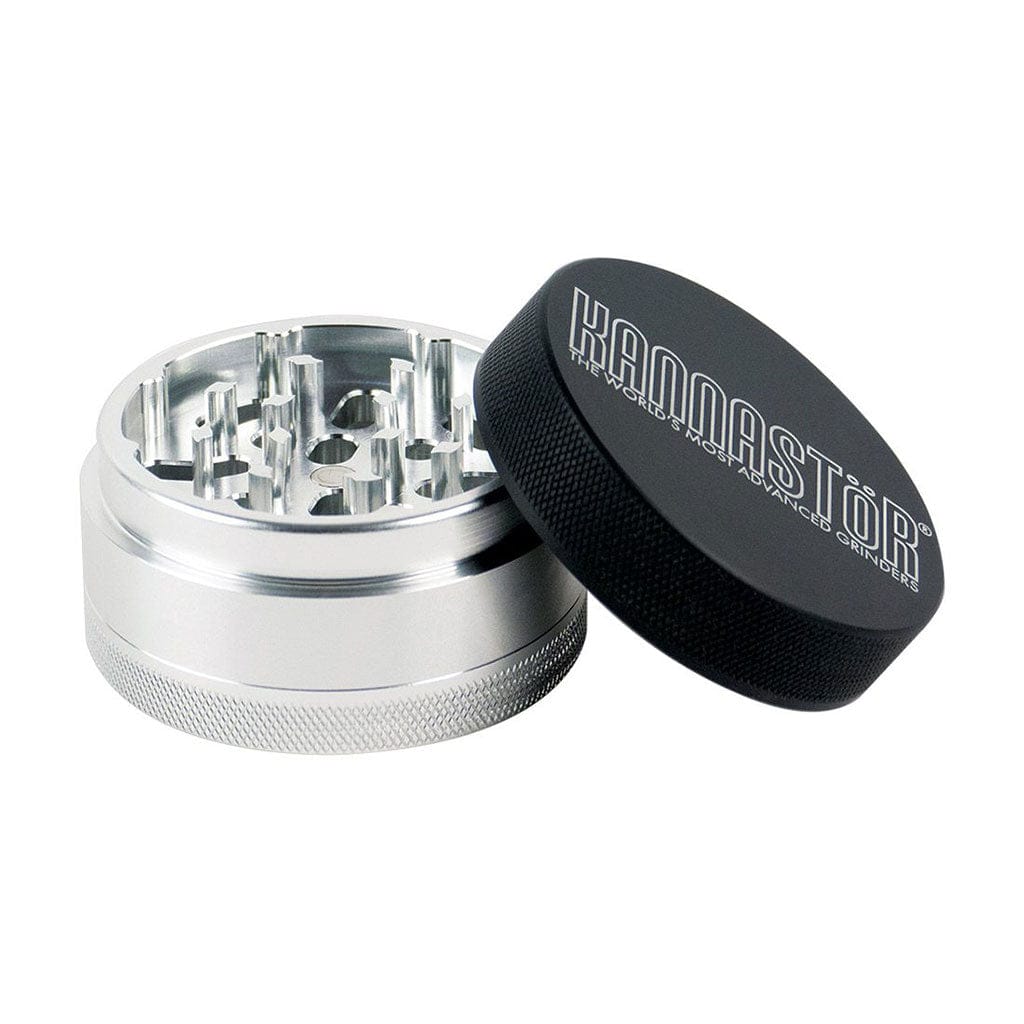 Angled close-up of a silver jar grinder with its black knurled lid beside it, showing internal teeth and the Ryot 4Pc Jar Body Grinders branding.