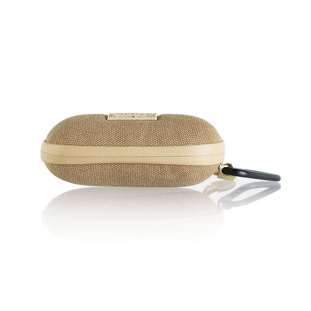 Side profile of a tan, textured Ryot Hardcase with a beige zipper band and attached black carabiner reflected on a glossy white surface