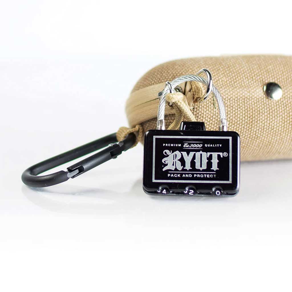 Close-up frontal view of a black Ryot Hardcase padlock attached to a beige textured case with a black carabiner nearby.