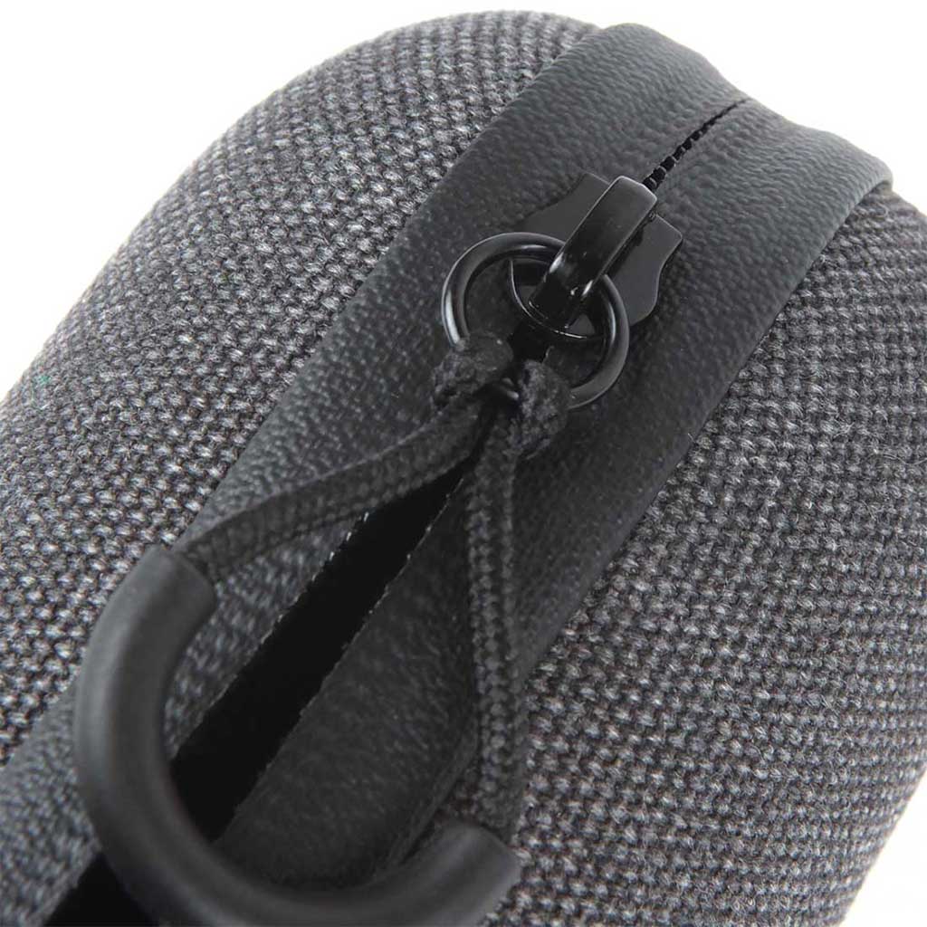 Diagonal close-up of the textured gray fabric and black zipper pull of the Ryot Hardcase, shot from above-left.