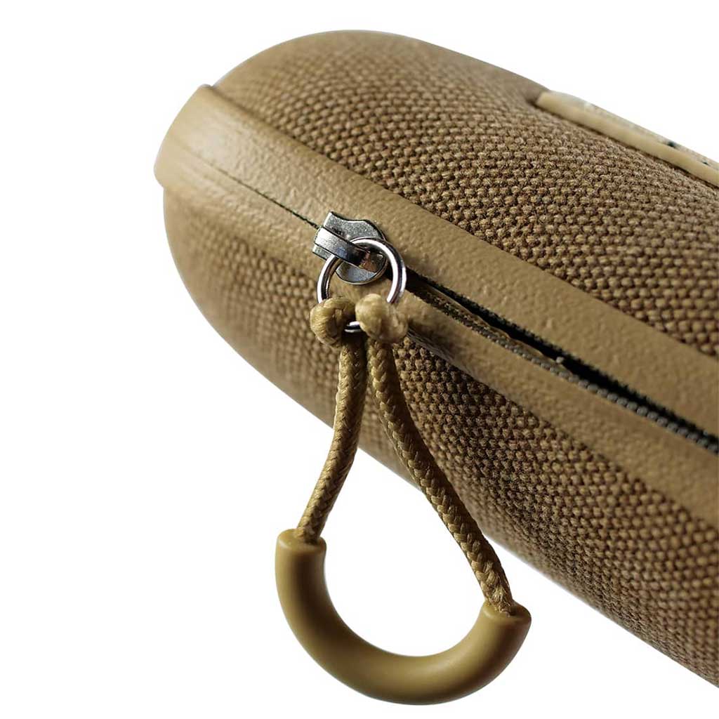 Close-up angled view of the tan Ryot Hardcase zipper pull and textured fabric exterior against a white background
