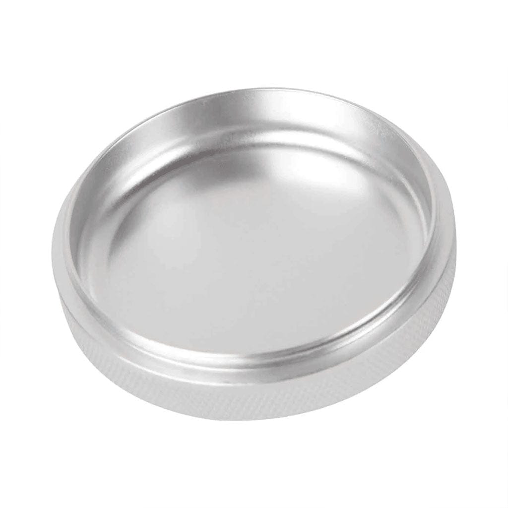 Close-up angled view of the silver Ryot 4Pc Jar Body Grinders metal lid resting on a white background, showing its smooth recessed top and knurled edge.