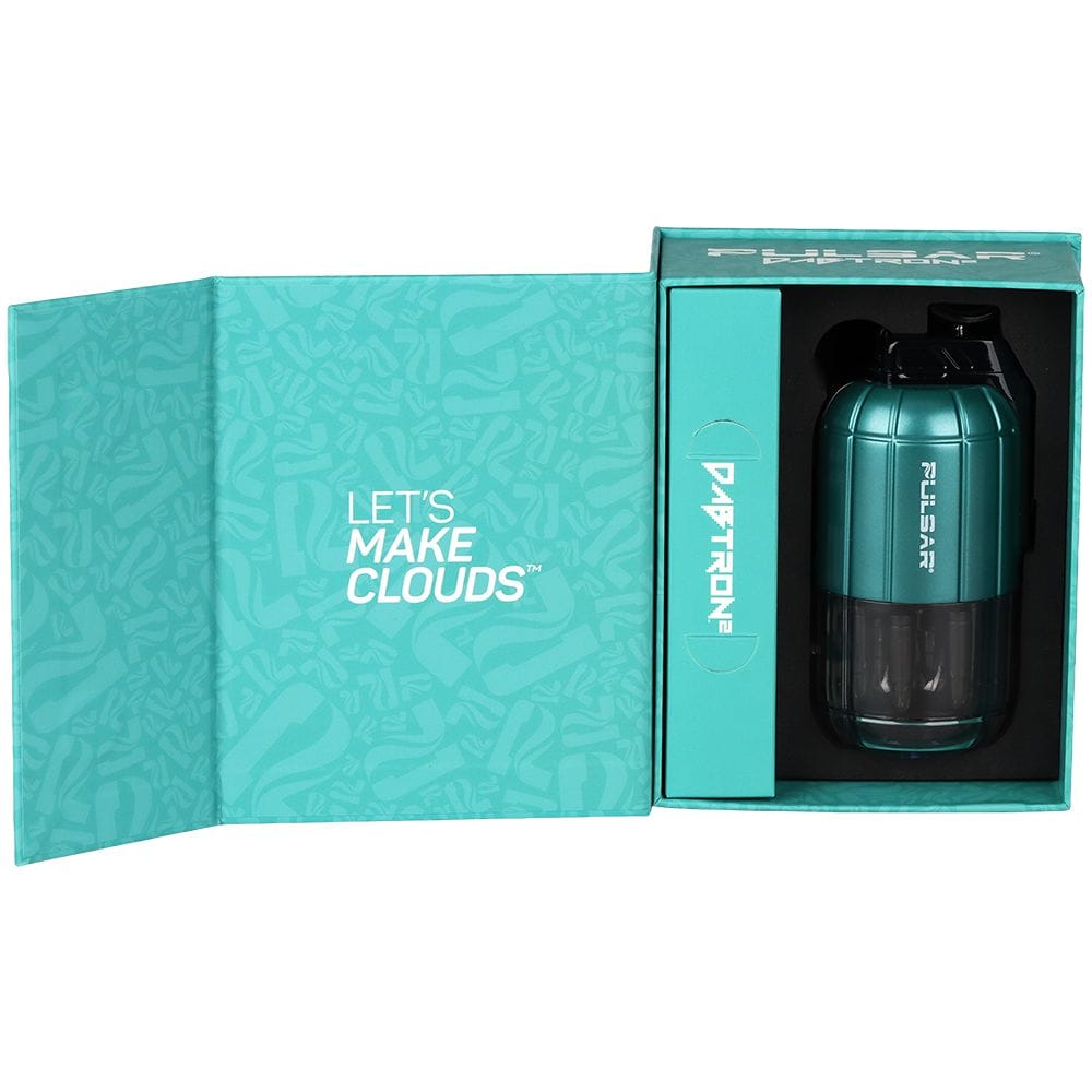 Right-angle view of the teal Pulsar Dabtron 2.0 Electric Dab Rig | 1500Mah nestled in its open turquoise box next to the "Let's Make Clouds" inner flap.