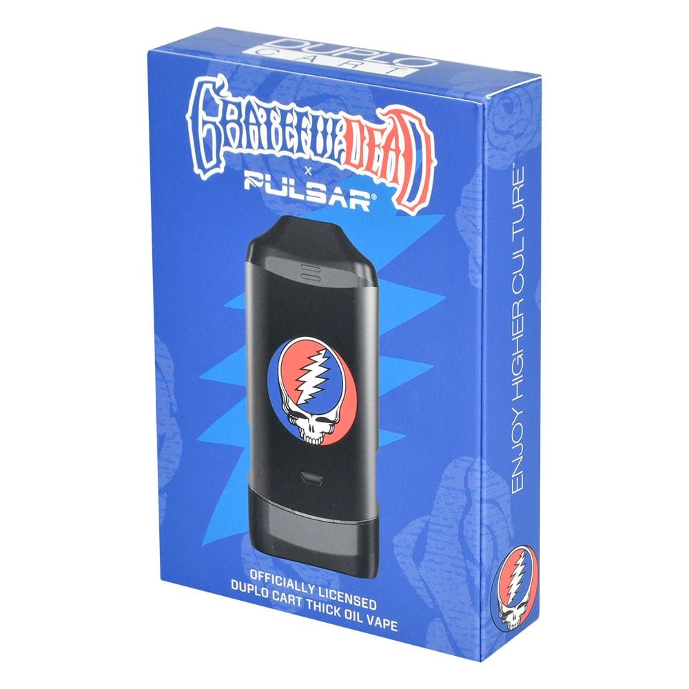 Three-quarter front view of the Grateful Dead X Pulsar Duplocart Vaporizer - 650Mah box showing a black pod with a Grateful Dead skull logo on a bright blue packaged background.