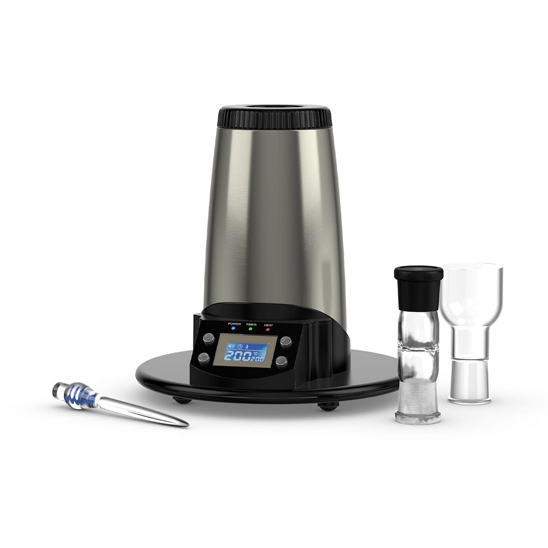 Front three-quarter view of the stainless steel Arizer V-Tower Desktop Vaporizer on a black circular base with a lit blue LCD and three glass accessories arranged to its right.
