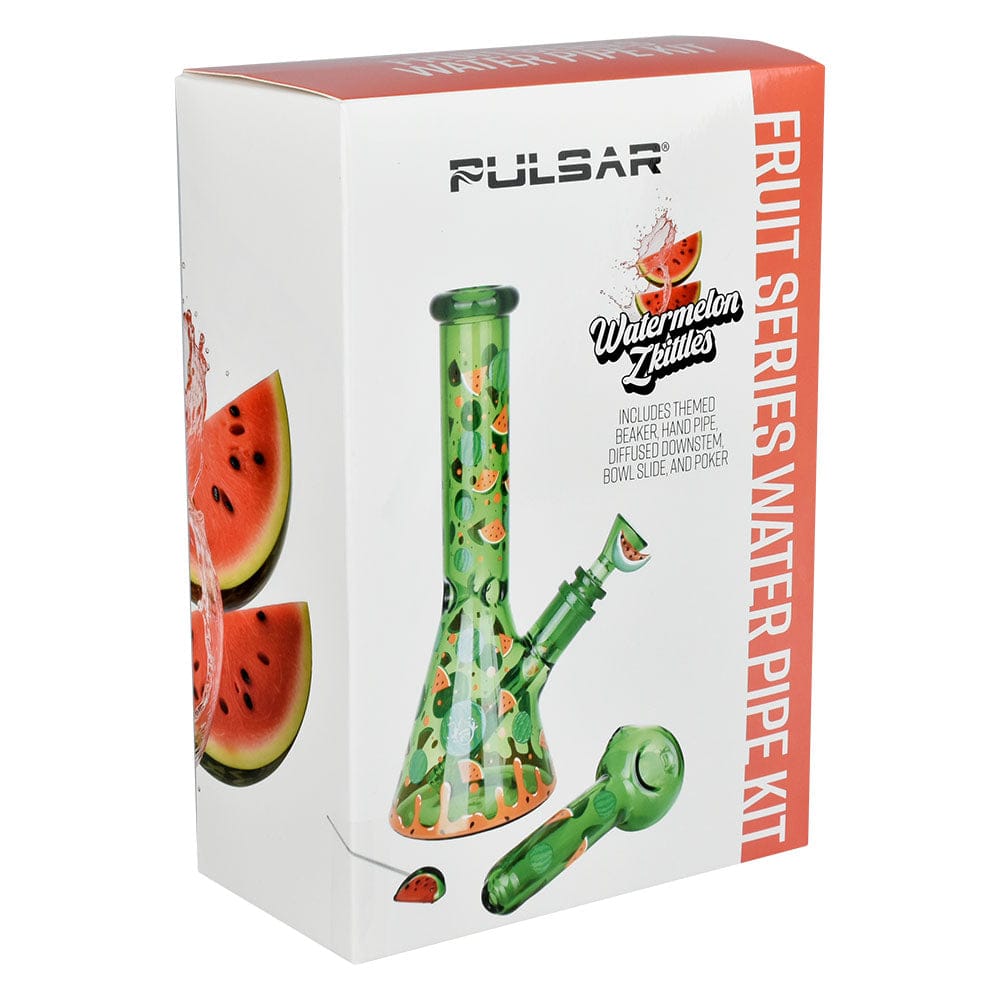 Angled front view of the box showing the Pulsar Fruit Series Watermelon Zkittles Herb Pipe Glow Duo - 10" / 14Mm F with a green watermelon-patterned beaker and matching hand pipe illustration on a white background.