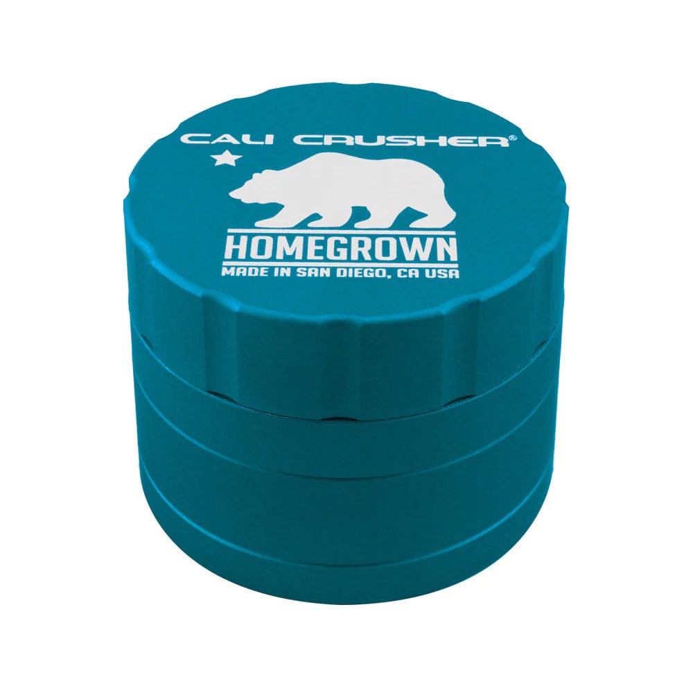 Front view of the Cali Crusher Homegrown Grinder 4pc, a dark-colored grinder with branding visible on its lid.