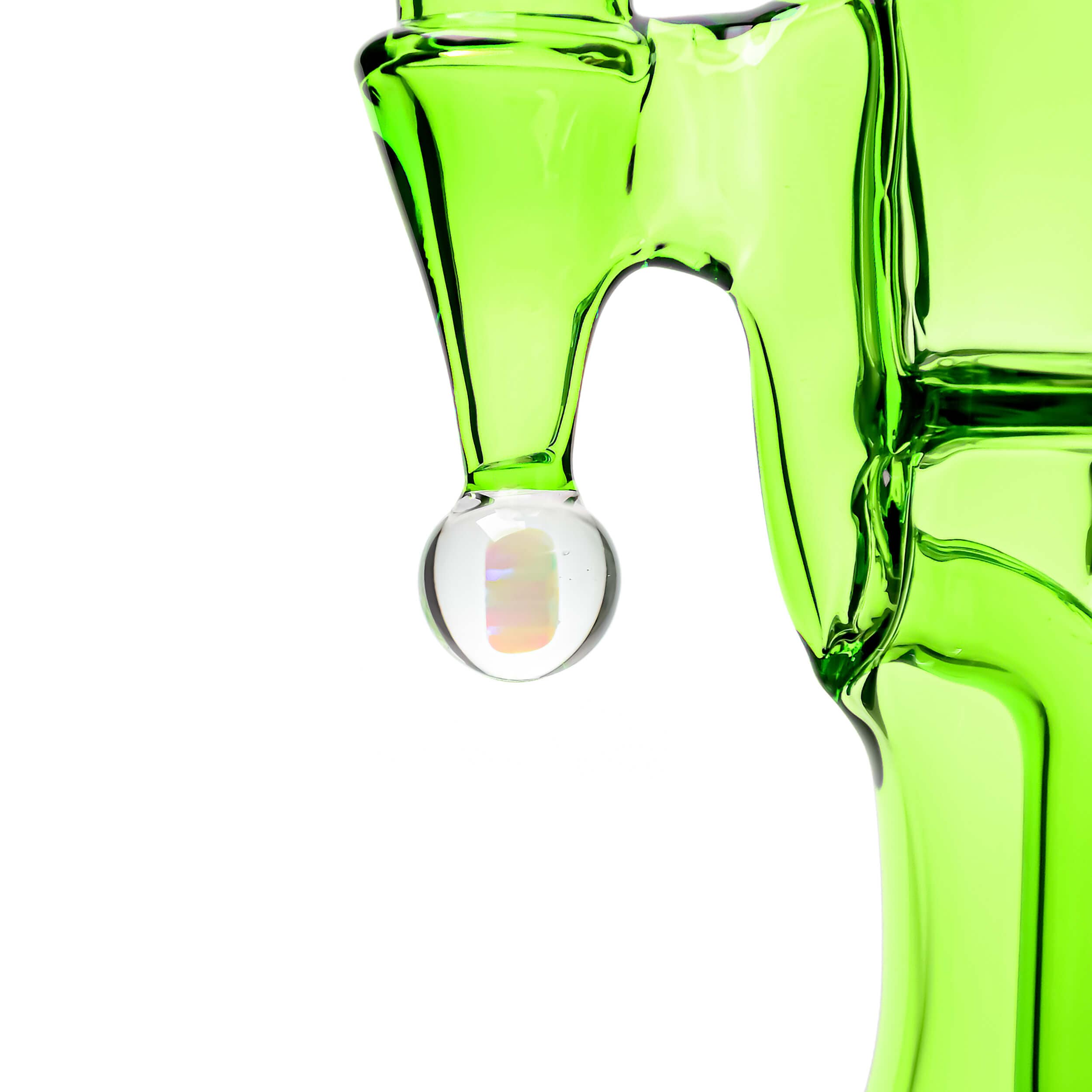 A close-up shot of the COLORED OPAL SHOWERHEAD RECYCLER, showcasing its green glass construction and unique showerhead design.