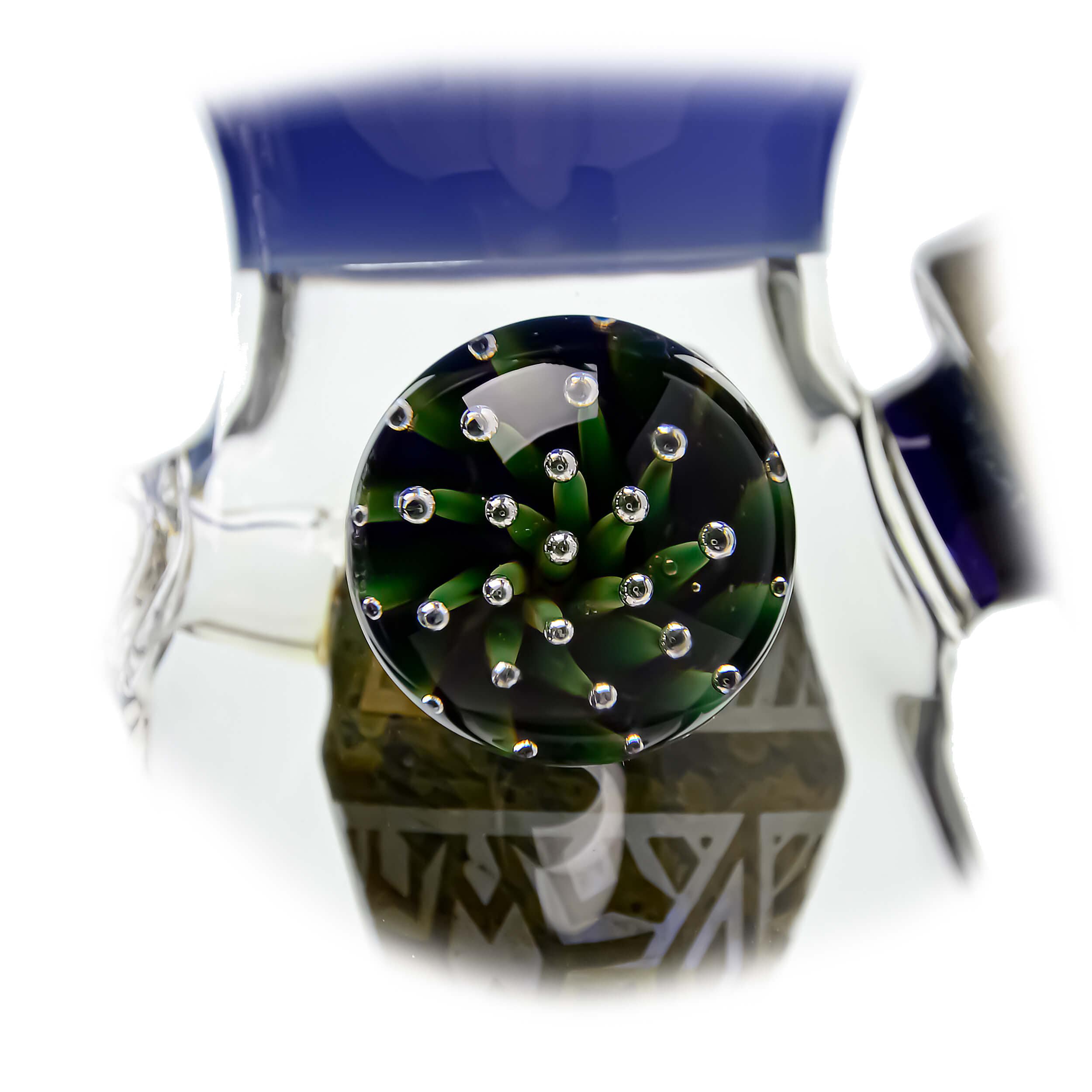 A close-up, angled view of the ETCH DAB RIG V2| showcasing its clear glass construction and unique etched details.