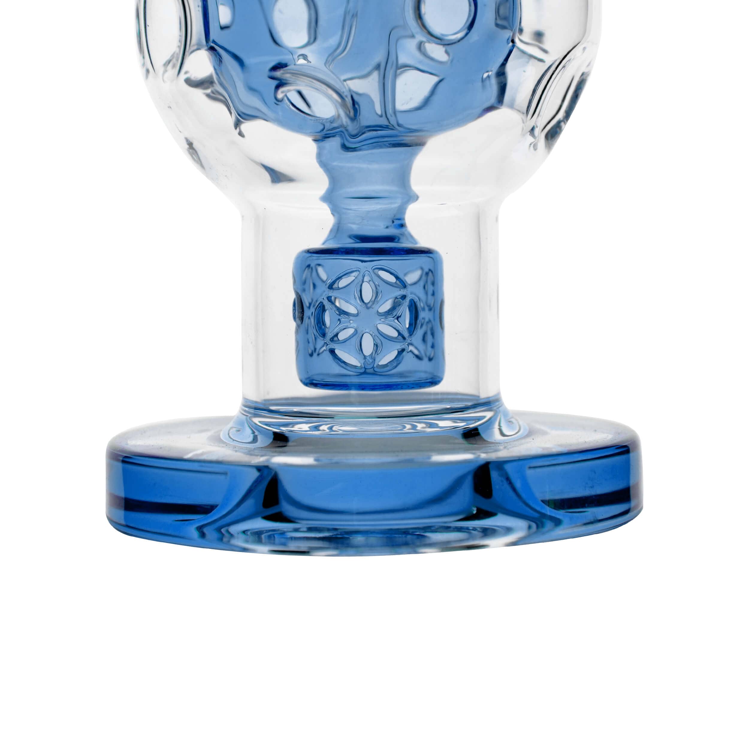Close-up, low-angle view of the EXOSPHERE, showcasing its blue glass base and intricate patterned design.