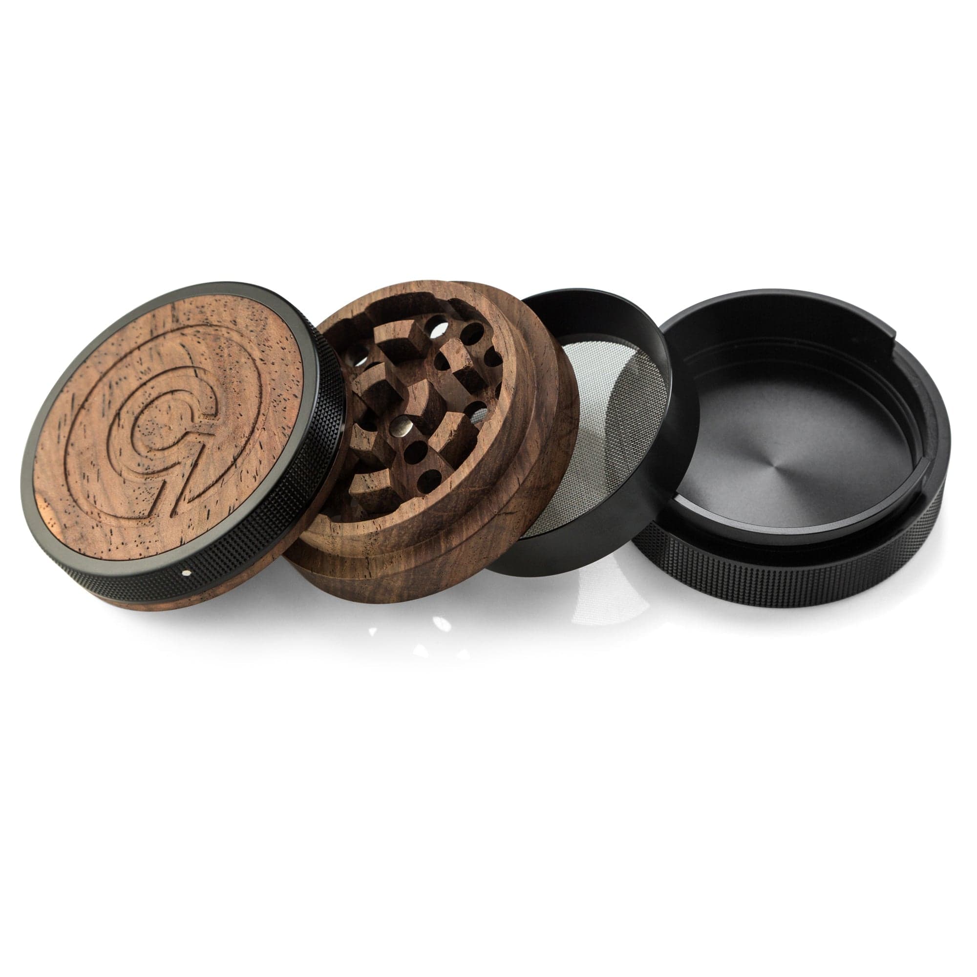 A disassembled SEQUOIA9 All Natural Wood to Herb Grinder, shown from above with a dark, reflective surface.