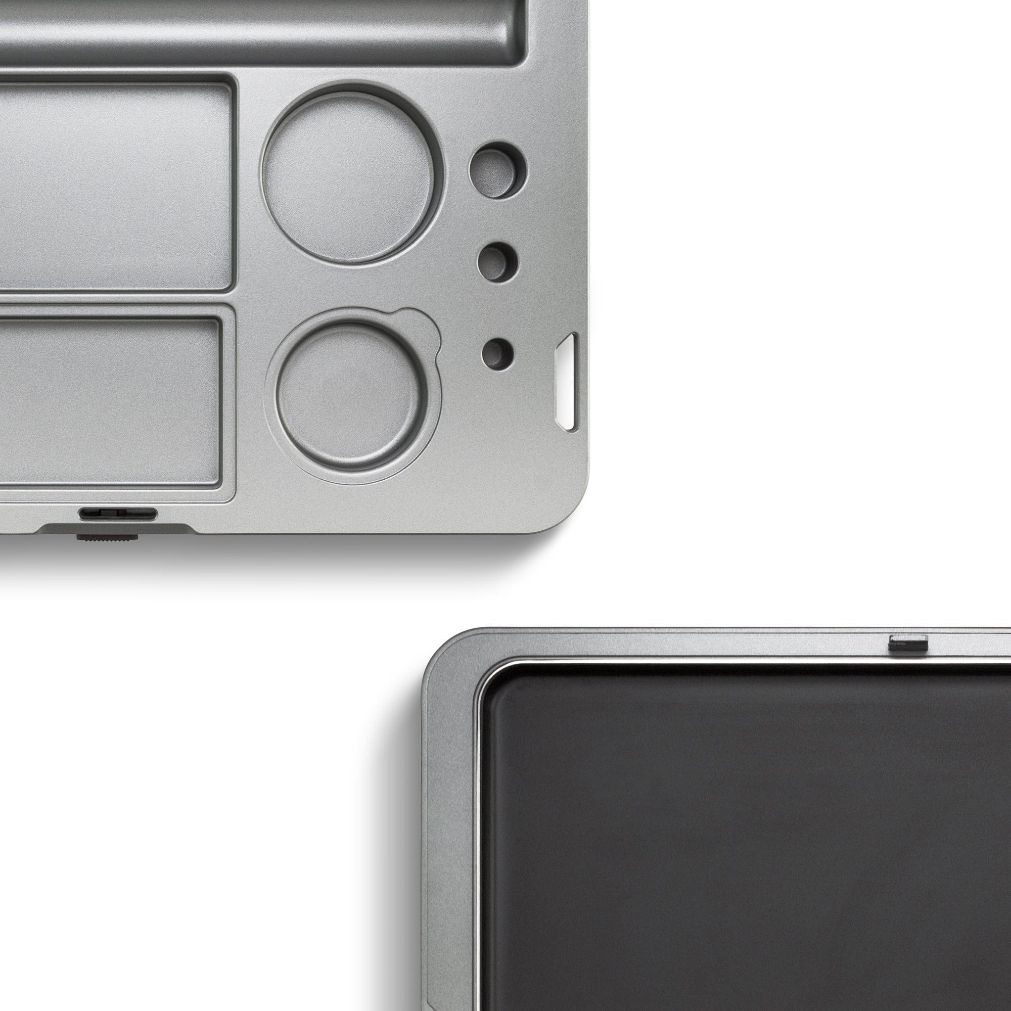Overhead view of the M.L.T.9 Portable Rolling Tray Survival Kit, showcasing its divided metallic surface and compact design.