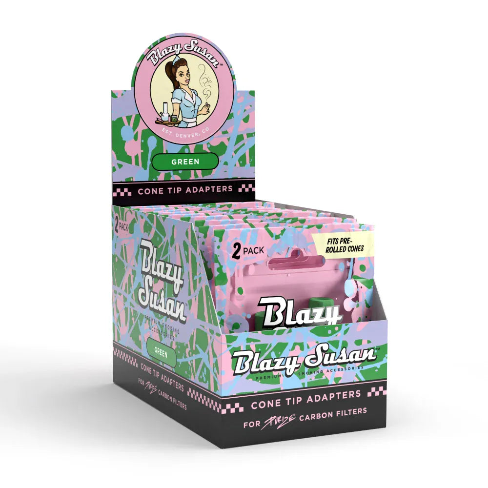 Three-quarter front view of a colorful counter display box of Blazy Susan Purize Cone Tip Adapters showing multiple pastel green-and-pink packaged 2‑packs and the round Blazy Susan logo topper.