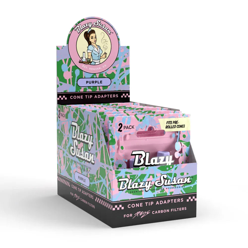 Angled front view of a pastel splatter display box for Blazy Susan Purize Cone Tip Adapters showing stacked purple 2‑pack sleeves.